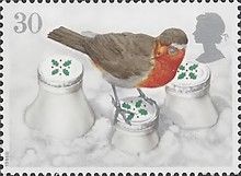 European Robin (Erithacus rubecula) on Snowcovered Milk Bott
