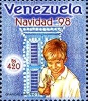 Boy standing in front of windows with bell
