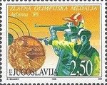 Gold medal and shooter figure