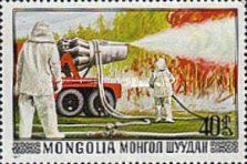 Men in protective suits fighting forest fire