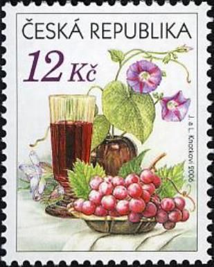 Still life with grape, glass of red wine and flowers