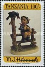 Bird in tree, boy seated on fence