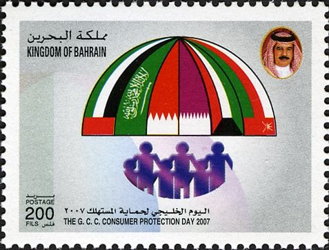 People under umbrella with GCC flags