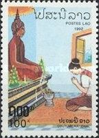 Woman praying before Buddha