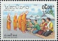 People giving food to monks