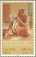 Monk writing palm leaf manconuscript