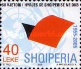 Folded red sheet in front of UN emblem