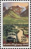 Truck on Alaska Highway with Mountains in Background