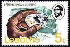 Hand holding Lesotho brown diamond