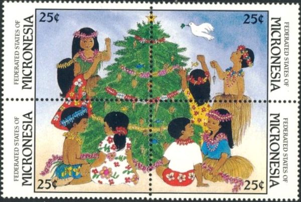 Boy in native dress and girl in floral dress at base of tree