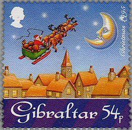 Santa with is Sleigh and Reindeer flying over the Rooftops