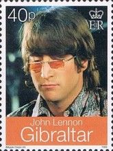John Lennon (musician) wearing orange glasses