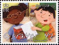 Children holding Books and Notebook Paper