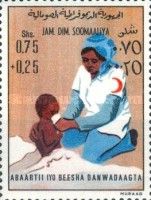Red Cross Nurse Feeding Child