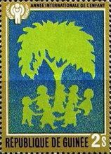 Children dancing around tree